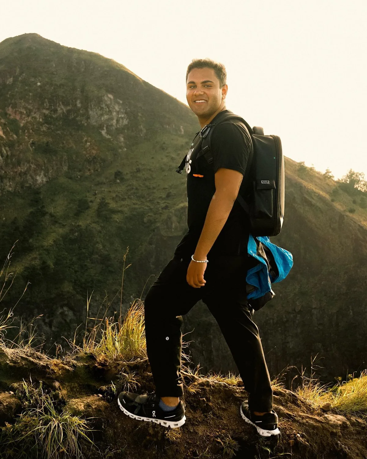 Sam climbing a mountain while traveling